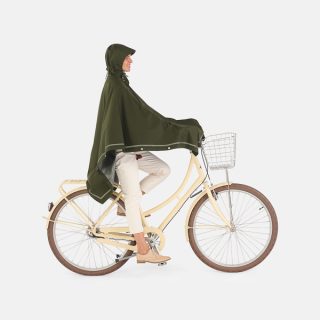 Imbris rain poncho green - woman cycling hood up